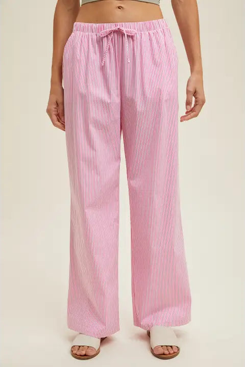 Pink striped pants worn by a person on a beige background